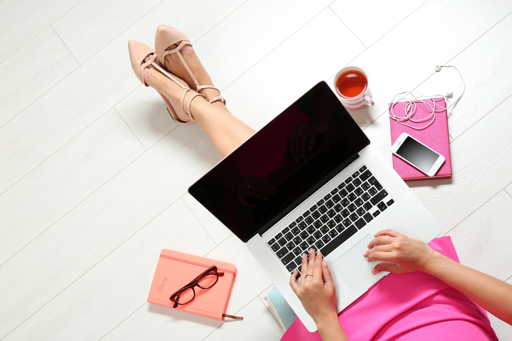 Top View of Young Woman Sitting on Floor with Laptop